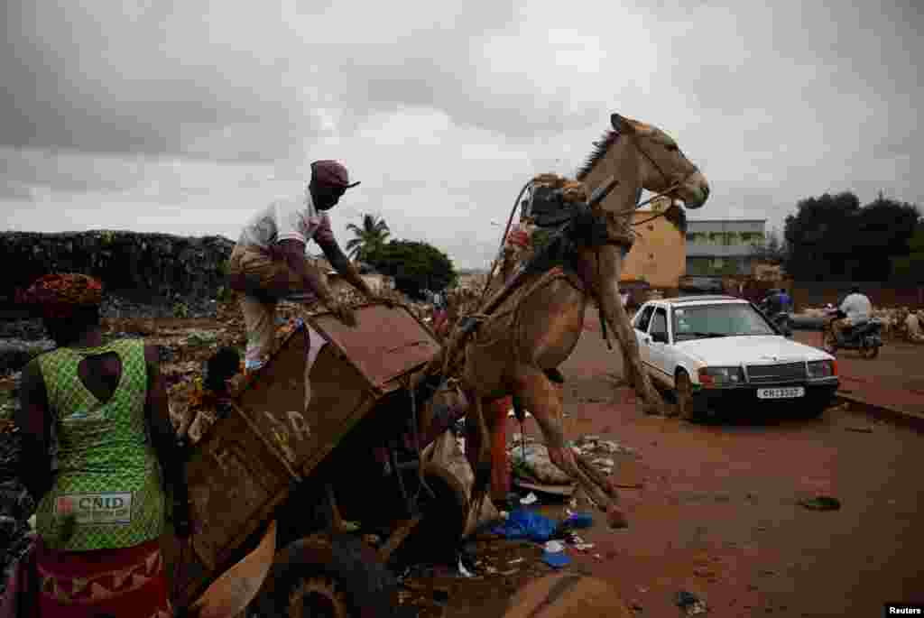A man unloads trash at a waste transfer station in Bamako, Mali.