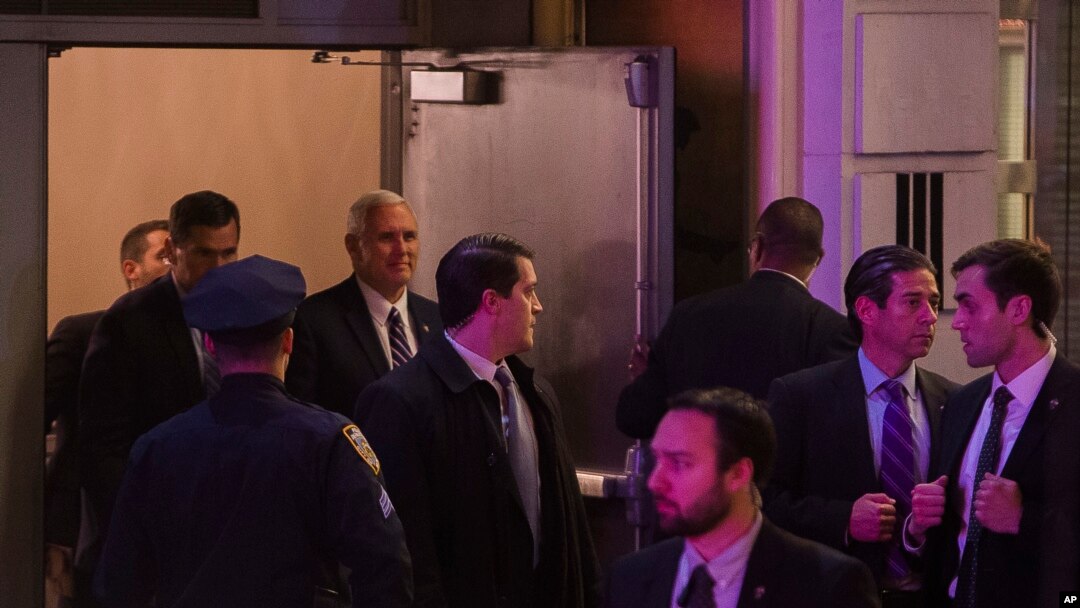 Vice President-elect Mike Pence, top center, leaves the Richard Rodgers Theatre after a performance of "Hamilton," in New York, Friday, Nov. 18, 2016. 