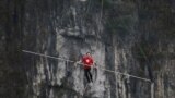 Freddy Nock of Switzerland walks on a tightrope during a competition in Wulong county, Chongqing, China. 