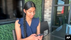 Shreya Nallamothu looks at her phone in Bloomington, Illinois, on May 9, 2023.
