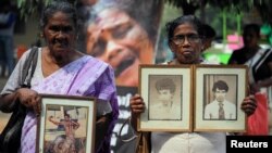 Women hold the portraits of their relatives, who disappeared at a protest, as they demand an investigation for those who went missing, during an event to mark the Valentine's Day in Colombo, Sri Lanka, February 14, 2020. 