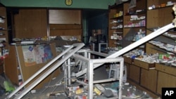 A damaged pharmacy is seen in the Bab Sabaa neighborhood of Homs October 10, 201