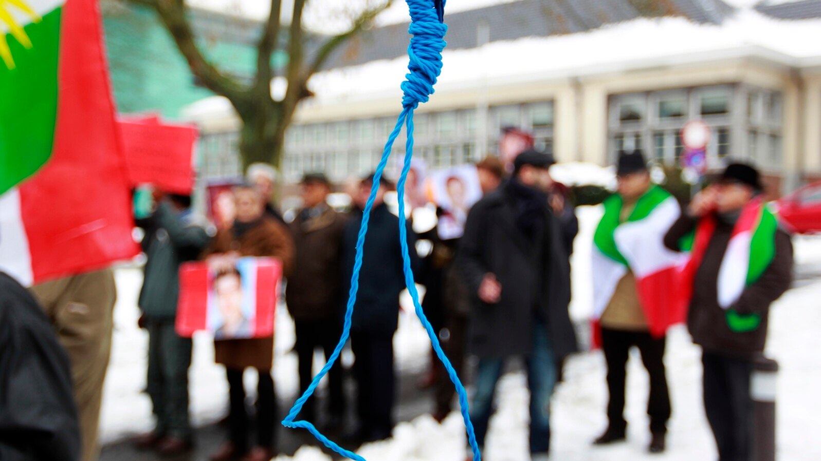 FILE - Iranian exiles shout slogans in front of a mock gallows to protest against executions in Iran during a demonstration outside the Iranian embassy in Brussels, Dec. 29, 2010.