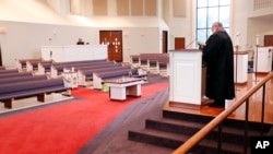 FILE - In this March 15, 2020 photo, the Rev. Kip Rush delivers his sermon in a sanctuary filled with mostly empty pews during a service amid coronavirus fears in Brentwood, Tenn.