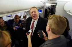 U.S. Secretary of State Mike Pompeo speaks to reporters aboard his plane en route to London, Jan. 29, 2020.