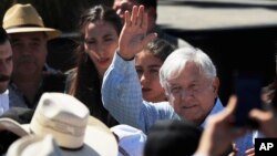 Mexican President Andres Manuel Lopez Obrador waves as he arrives for a meeting with dairy farmers in La Chona de Encarnacion de Diaz, Jalisco, Mexico, March 9, 2019.