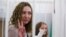 Journalists Yekaterina Andreeva and Darya Chultsova attend a court hearing in Minsk.