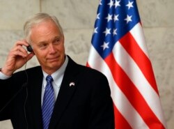 FILE - US Senator Ron Johnson listens Serbia's President Aleksandar Vucic in Belgrade, Serbia, Feb. 18, 2018.