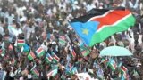 FILE - Thousands of Southern Sudanese wave the flag of their new country during a ceremony in the capital Juba on July 9, 2011, to celebrate South Sudan's independence from Sudan.