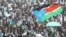 FILE - Thousands of Southern Sudanese wave the flag of their new country during a ceremony in the capital Juba on July 9, 2011, to celebrate South Sudan's independence from Sudan.