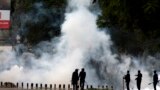 Kenyan police use tear gas to disperse Nairobi University Students, who rioted over the death of two of their colleagues, in Nairobi. The students said they wanted an explanation of how the two engineering students died within a day while in police custody.