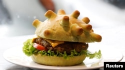 A burger with a bun shaped like a coronavirus is seen at a restaurant in Hanoi, Vietnam, March 25, 2020.
