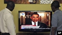 Kenyans watch U.S. President Barack Obama on television in Nairobi, Kenya, announcing the death of Osama bin Laden in Pakistan, Monday, May 2, 2011