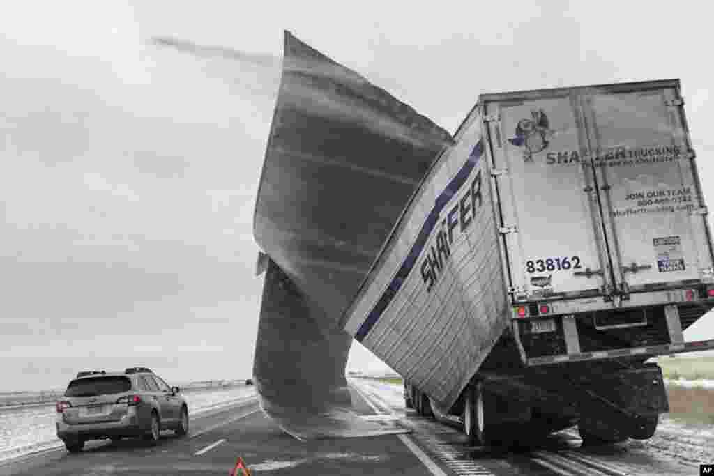 This photo released by the Nebraska State Patrol, shows a broken up trailer amid blowing snow on Interstate 80 near Bradshaw, Nebraska, Nov. 25, 2018. Blizzard-like conditions have closed highways and delayed air travel as a winter storm moved through the Midwest.
