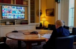 Britain's Prime Minister Boris Johnson attends a video conference in the study of 10 Downing Street in London, with other G-20 leaders summit, March 26, 2020.
