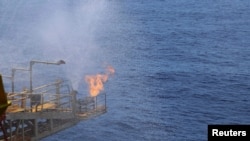 Flames are seen at a drilling platform for combustible ice after a completion of a 60-day mining trail in the Shenhu area of South China Sea, southeast of Zhuhai, Guangdong province, China, July 9, 2017