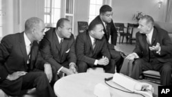 U.S. President Lyndon B. Johnson, right, talks with civil rights leaders in his White House office in Washington, D.C., Jan. 18, 1964.