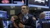 FILE - Traders work on the floor of the New York Stock Exchange (NYSE) March 4, 2016. 