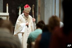 FILE - Cardinal Donald Wuerl, Archbishop of Washington, conducts Mass at St. Mathews Cathedral in Washington, Aug. 15, 2018.