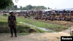 FILE - A soldier stands near the Cox's Bazar refugee camp in Bangladesh, near Rakhine state, Myanmar, during a trip by United Nations envoys to the region, April 29, 2018. 