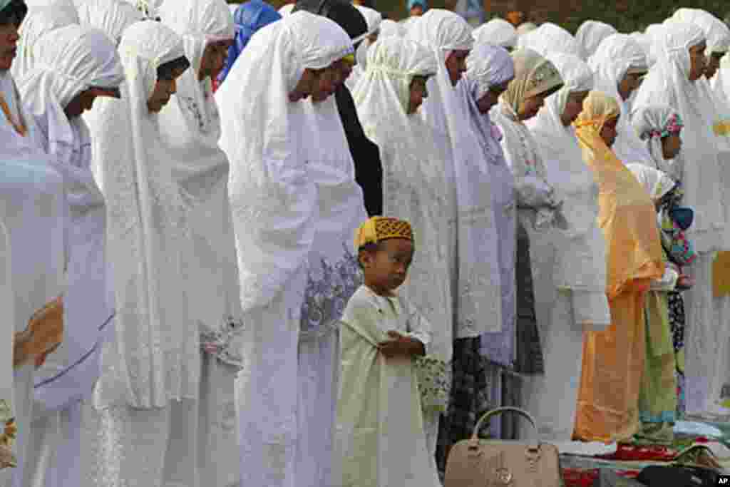 A Muslim boy prays during Eid al-Fitr prayer that marks the end of the holy fasting month of Ramadan in Jakarta, Indonesia, Aug. 30, 2011. AP