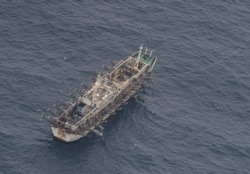 FILE - A fishing boat is seen from an aircraft of the Ecuadorian navy after a fishing fleet of mostly Chinese-flagged ships was detected near the Galapagos Islands' exclusive economic zone, in the Pacific Ocean, Aug. 7, 2020.