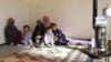 Syrian refugees, who fled the violence in the Syrian town of Qusair, sit at a temporary home, in the hillside town of Arsal in Lebanon's Bekaa Valley, March 5, 2012.