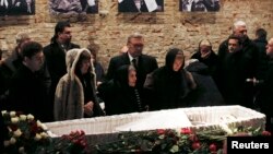 Mourners, including Dina Eidman (front row, third from left), mother of Russian leading opposition figure Boris Nemtsov, and Mikhail Kasyanov (center, rear), an opposition leader and former Russian prime minister, attend a memorial service before the fune