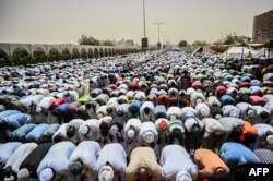 Sudanese protesters attend a Friday prayer outside the army headquarters in the capital Khartoum, April 19, 2019.