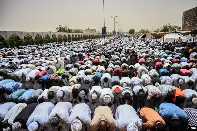 Sudanese protesters attend a Friday prayer outside the army headquarters in the capital Khartoum, April 19, 2019.