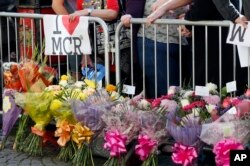 People attend a vigil in Albert Square, Manchester, England, May 23, 2017, the day after the suicide attack at an Ariana Grande concert that left 22 people dead as it ended Monday night.