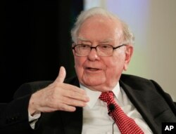 FILE - Warren Buffett speaks with CNBC's Becky Quick at a national conference sponsored by the Purpose Built Communities group that Buffett supports, in Omaha, Neb., Oct. 3, 2017.