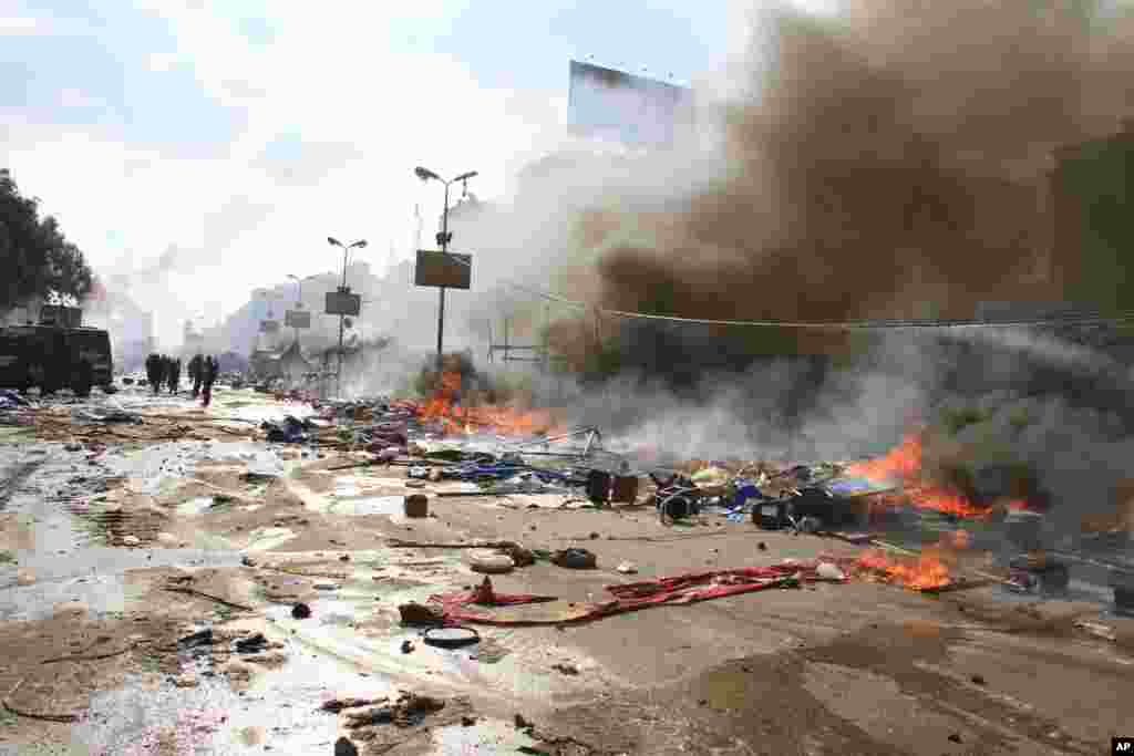 Fires burn as Egyptian security forces clear a sit-in by supporters of ousted Islamist President Mohammed Morsi in the eastern Nasr City district of Cairo, Egypt, Wednesday, Aug. 14, 2013. Egyptian security forces, backed by armored cars and bulldozers, m