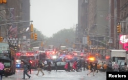 Emergency vehicles fill the street at the scene after a helicopter crashed atop a building in Times Square and caused a fire in the Manhattan borough of New York, New York, U.S., June 10, 2019.