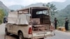 Security personnel stand near a damaged police vehicle at the site of a bomb explosion, in Malam Jabba at Swat district of Khyber Pakhtunkhwa province on Sept. 22, 2024. 