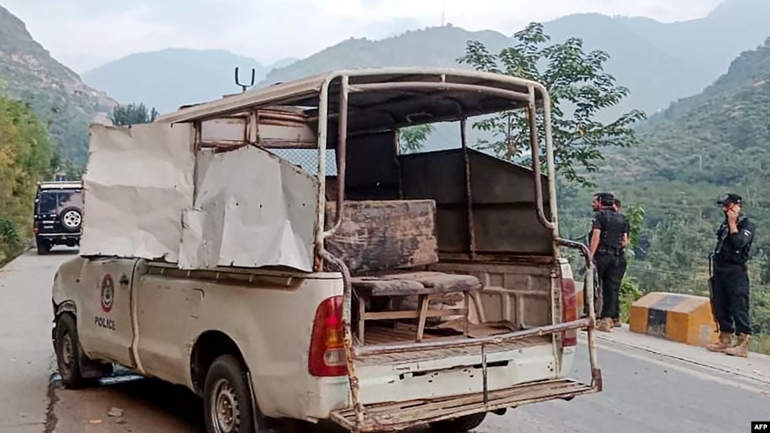 Security personnel stand near a damaged police vehicle at the site of a bomb explosion, in Malam Jabba at Swat district of Khyber Pakhtunkhwa province on Sept. 22, 2024. 