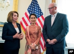 FILE - Myanmar leader Aung San Suu Kyi, center, meets House Minority Leader Nancy Pelosi of Calif.. and Rep. Joseph Crowley, D-N.Y., on Capitol Hill in Washington, Sept. 15, 2016.
