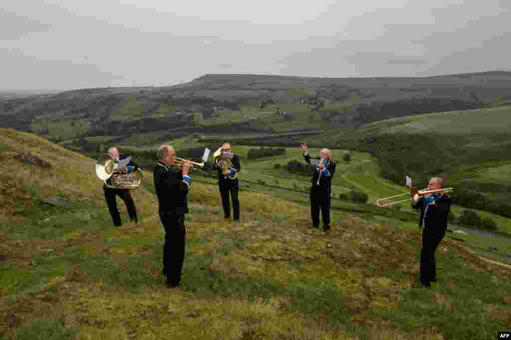 Members of the &#39;Meltham and Meltham Mills Band&#39; practice together for the first time in Worlow Quarry, above the village of Marsden, near Huddersfield, northern England, June 30, 2020.