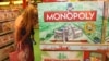 A woman inspects a display of the latest South African version of the world-famous Monopoly board game. (D. Taylor/ VOA)