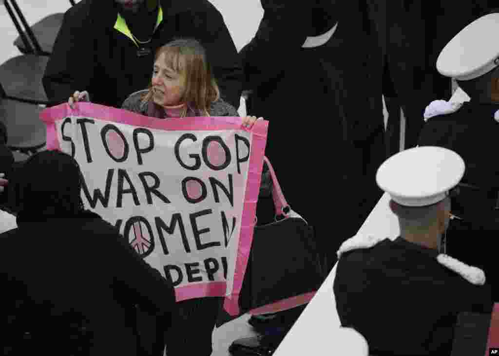 A protester displays a sign during the 58th Presidential Inauguration for President Donald Trump at the U.S. Capitol in Washington, Jan. 20, 2017. 