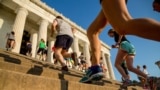 In this May 25, 2016 photo, members of the running group "November Project" run up and down the stairs of the Lincoln Memorial, in Washington. The group uses fun and friendship to keep people moving. (AP Photo/Andrew Harnik)