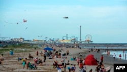 Beachgoers enjoy a day of sunshine at Galveston Beach on May 2, 2020 in Galveston, Texas, a day after the beaches reopened amid the coronavirus pandemic. 
