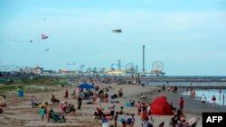 Beachgoers enjoy a day of sunshine at Galveston Beach on May 2, 2020 in Galveston, Texas, a day after the beaches reopened amid the coronavirus pandemic. 