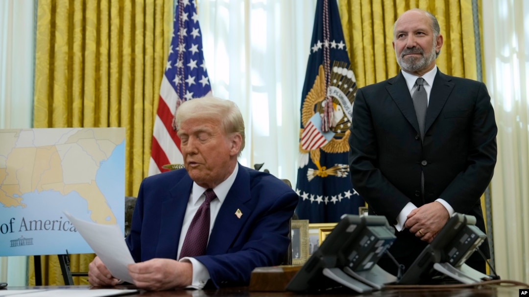 Howard Lutnick, President Donald Trump's choice to serve as commerce secretary, listens as Trump speaks after signing an executive order in the Oval Office of the White House, Feb. 13, 2025, in Washington.