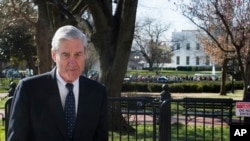 FILE - Special Counsel Robert Mueller is seen passing the White House in Washington, March 24, 2019.