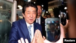 Japan's Prime Minister Shinzo Abe, leader of the Liberal Democratic Party, greets his supporters after making a speech at an election campaign rally in Tokyo, Japan, Oct. 20, 2017.