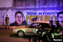 FILE - A Venezuelan soldier on patrol at the slum of Petare, Caracas, May 23, 2013.