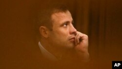 File - Oscar Pistorius sits in the high court for the fourth day of sentencing in Pretoria, South Africa, October 2014.