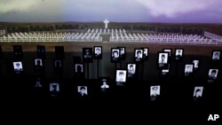 FILE - Photographs of Argentine soldiers who died in the Falklands War between Argentina and Great Britain are displayed inside Malvinas Museum in Buenos Aires, Argentina, Sept. 18, 2015. The two countries reached a deal, Dec. 20, 2016, to identify the remains of over 100 Argentine soldiers buried in the Falkland Islands after the 1982 war. 