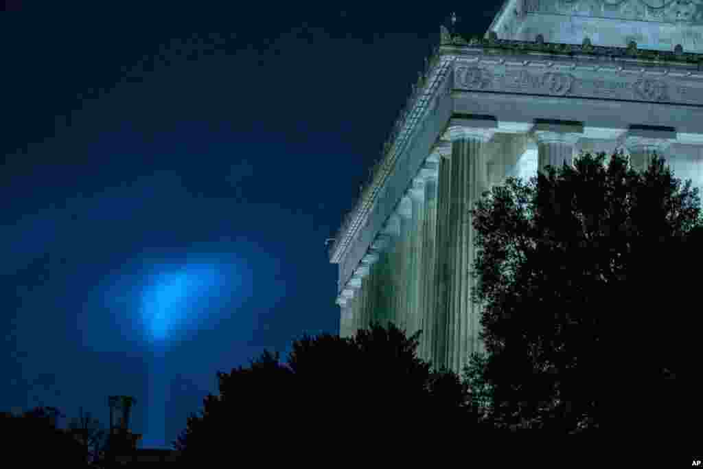 A beam of light is seen near to the Lincoln Memorial, as part of the Towers of Light Tribute marking the 19th anniversary of the 9/11 attack on the Pentagon, Sept. 9, 2020, in Washington. (AP Photo)